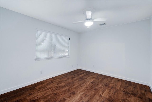 spare room with ceiling fan and dark hardwood / wood-style flooring