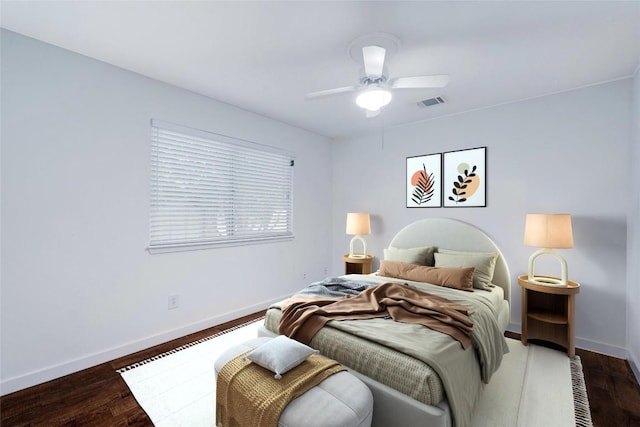 bedroom with dark hardwood / wood-style floors and ceiling fan