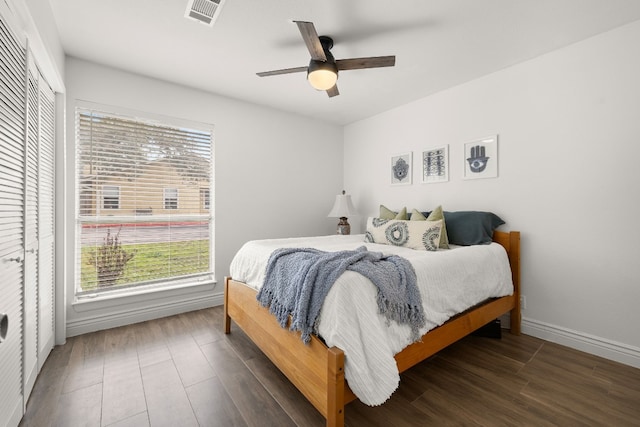 bedroom featuring dark hardwood / wood-style flooring, a closet, and ceiling fan