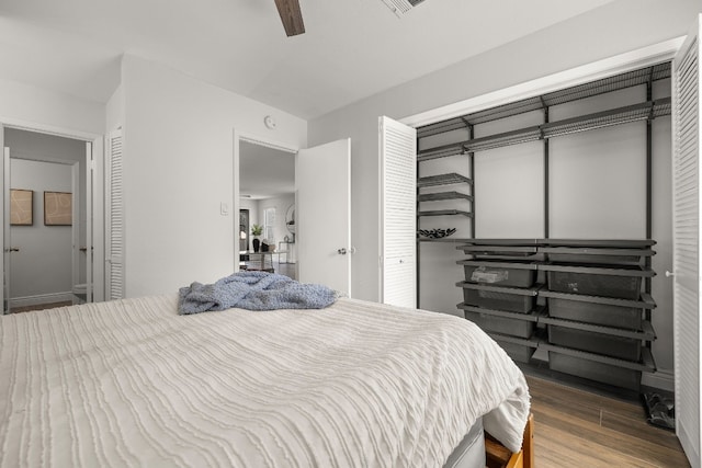 bedroom with wood-type flooring and ceiling fan