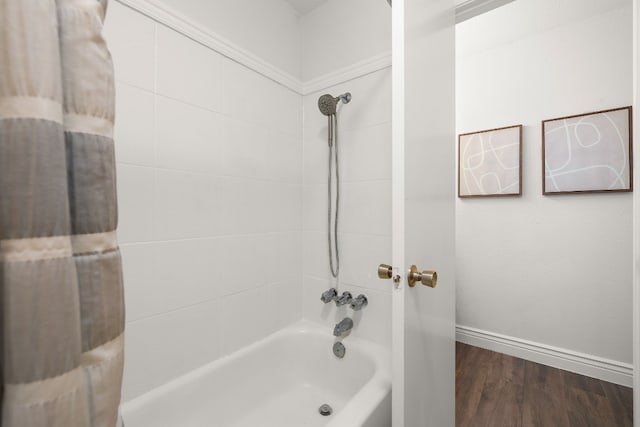 bathroom with wood-type flooring and tiled shower / bath combo