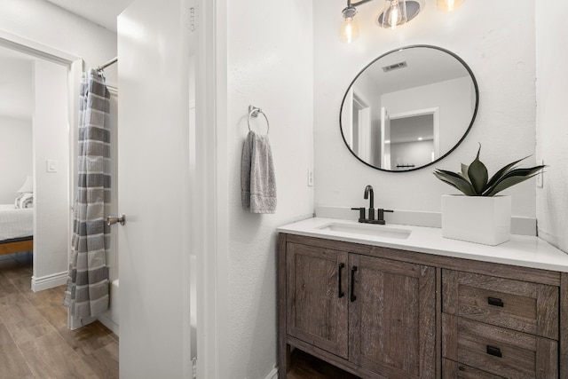 bathroom with vanity and wood-type flooring