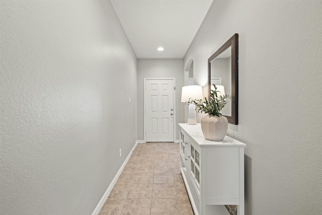 corridor with light tile patterned floors