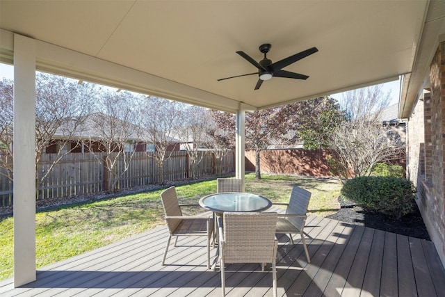 deck featuring ceiling fan and a yard