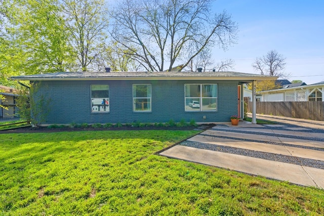 view of front of home with a front lawn and a patio