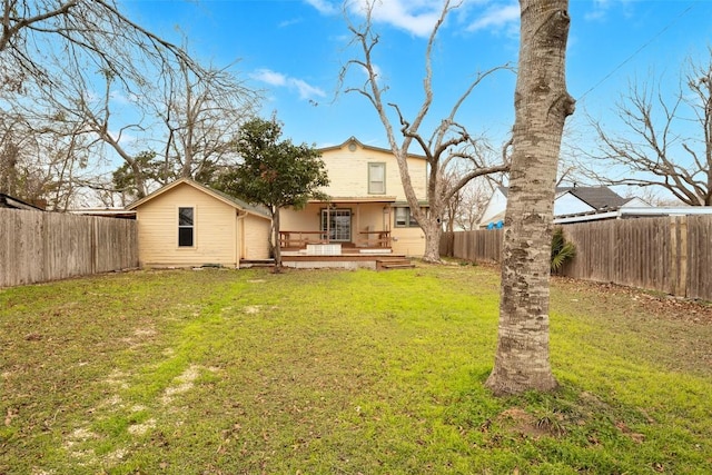 back of house featuring a yard and a deck