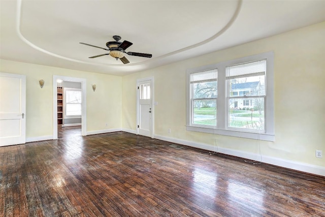 empty room featuring ceiling fan and dark wood-type flooring