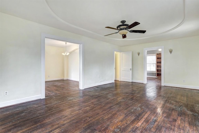 unfurnished room with dark hardwood / wood-style floors and ceiling fan with notable chandelier