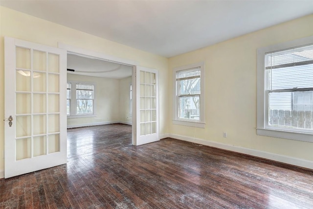 unfurnished room featuring french doors and dark hardwood / wood-style flooring