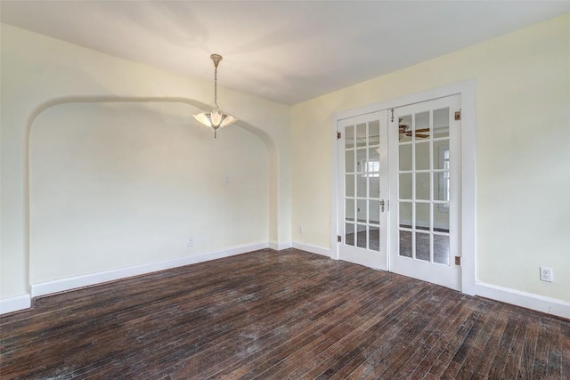 unfurnished room featuring french doors and dark wood-type flooring