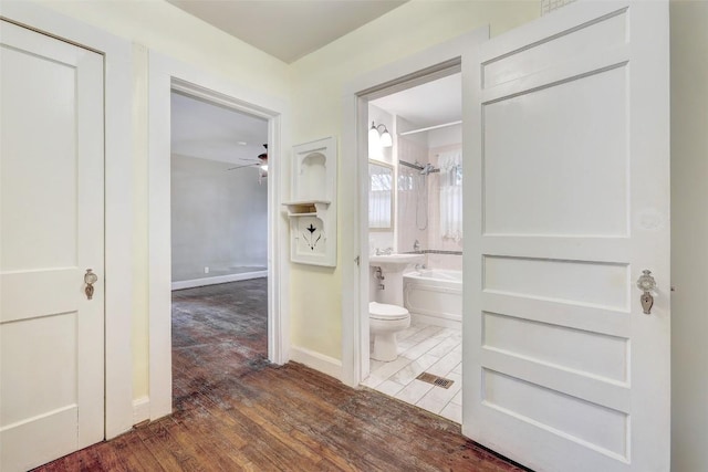 bathroom featuring toilet, wood-type flooring, separate shower and tub, and ceiling fan