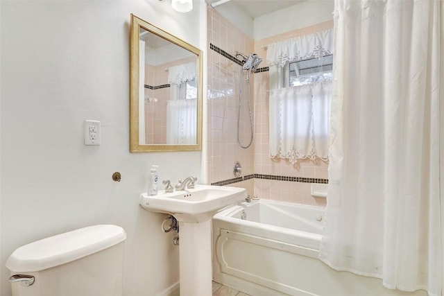 bathroom with shower / bath combo with shower curtain and toilet