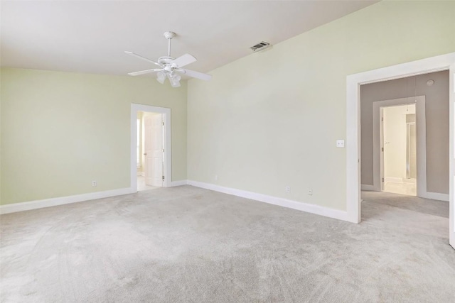 empty room featuring ceiling fan and light carpet