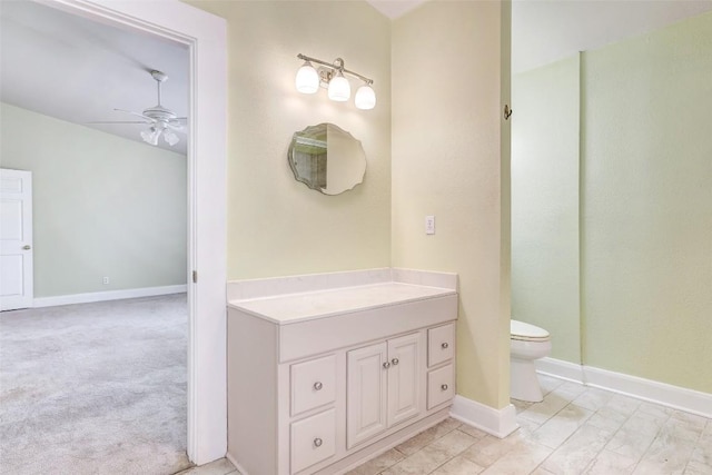 bathroom featuring ceiling fan, vanity, and toilet