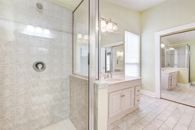 bathroom with tile patterned floors, vanity, and an enclosed shower