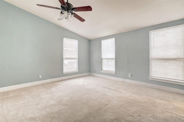 unfurnished room with ceiling fan, light colored carpet, and vaulted ceiling