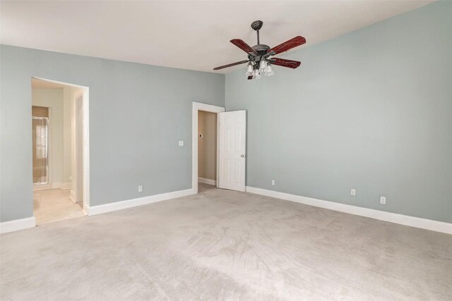 unfurnished bedroom with light colored carpet, ceiling fan, lofted ceiling, and ensuite bathroom