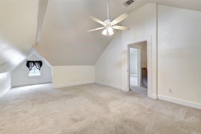 additional living space with light colored carpet, ceiling fan, and lofted ceiling