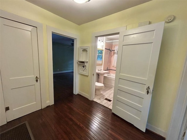 1710 Lexington St, Taylor, TX 76574 - hallway featuring hardwood / wood-style floors and baseboards