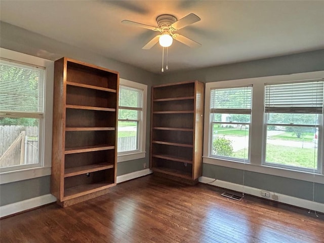 1710 Lexington St, Taylor, TX 76574 - empty room with dark wood finished floors, healthy amount of natural light, and a ceiling fan