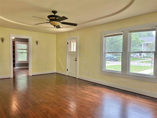 1710 Lexington St, Taylor, TX 76574 - unfurnished room with healthy amount of natural light, dark wood-type flooring, and ceiling fan