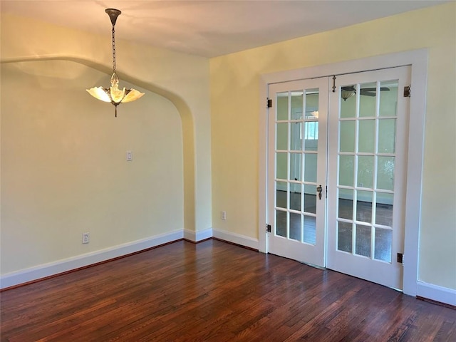 1710 Lexington St, Taylor, TX 76574 - unfurnished room featuring dark wood-style floors, french doors, and arched walkways