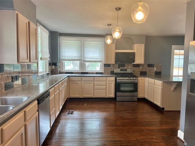1710 Lexington St, Taylor, TX 76574 - kitchen featuring stainless steel appliances, healthy amount of natural light, decorative backsplash, and dark wood-style floors