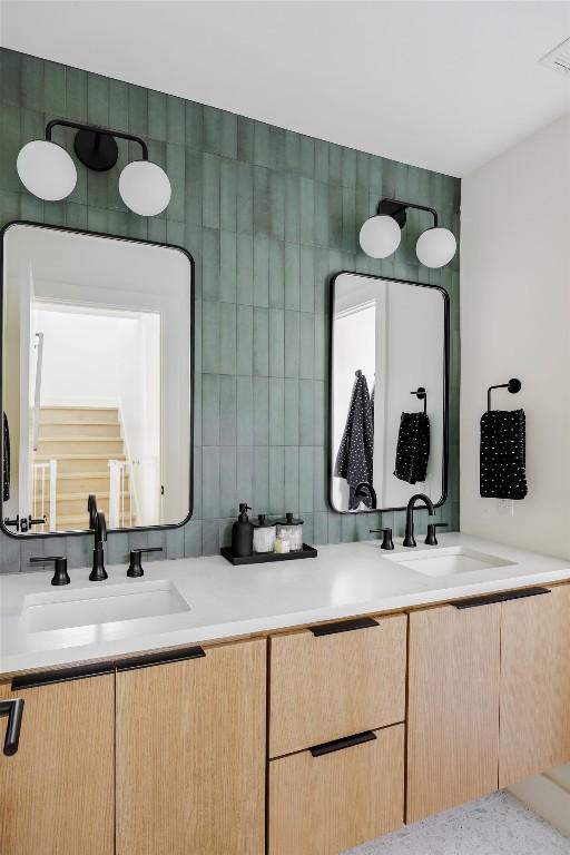 bathroom featuring vanity, backsplash, and tile walls