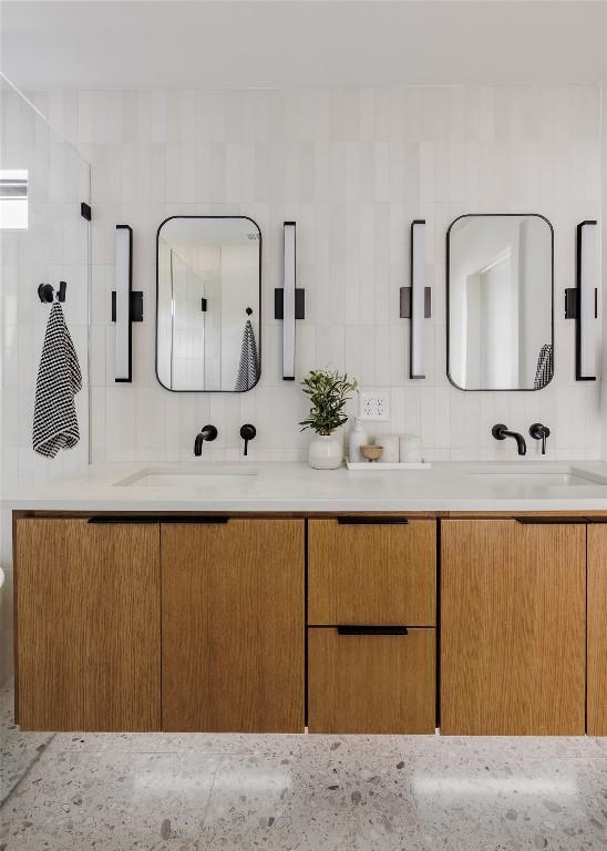 bathroom with tasteful backsplash and vanity