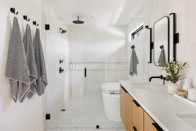 bathroom featuring vanity and independent shower and bath