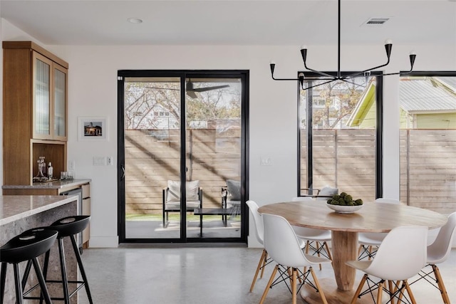 dining area with an inviting chandelier