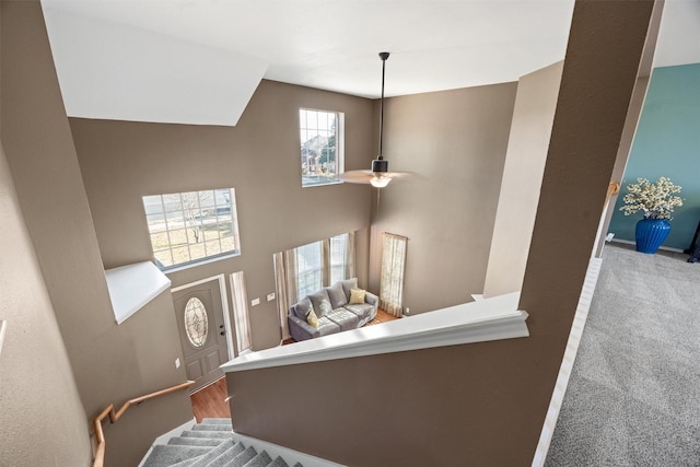 stairway with ceiling fan and hardwood / wood-style floors