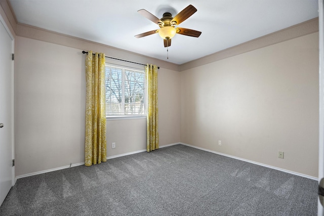 unfurnished room with ceiling fan and dark carpet