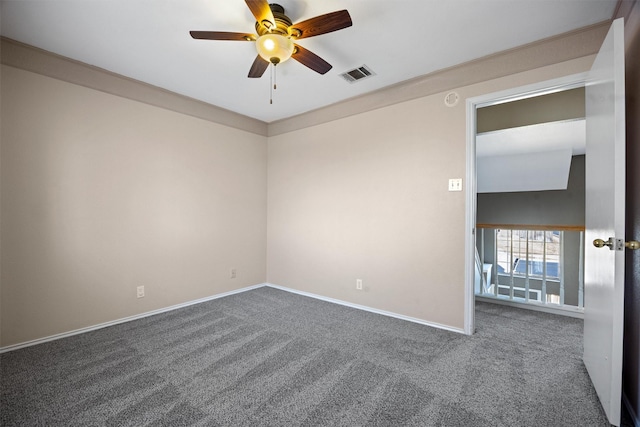 carpeted spare room with ceiling fan