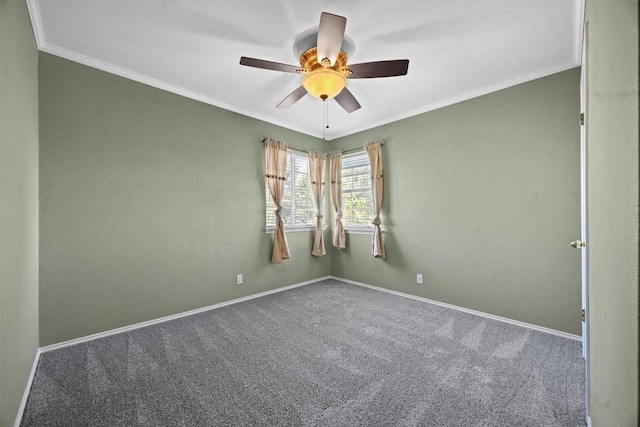 spare room with crown molding, carpet flooring, baseboards, and ceiling fan