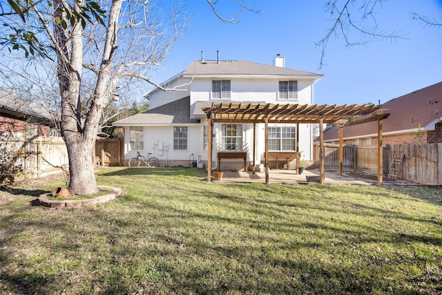 back of property featuring a yard, a pergola, and a patio