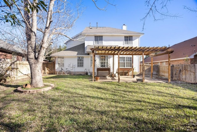 rear view of house featuring a pergola, a patio, a fenced backyard, a chimney, and a yard