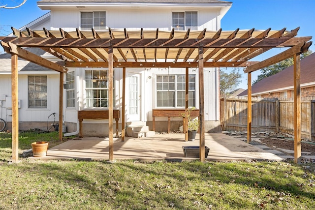 back of property featuring a pergola, a patio, and a lawn