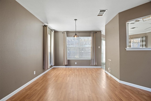 unfurnished dining area with light hardwood / wood-style flooring