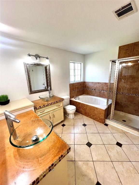 full bath with tile patterned flooring, visible vents, toilet, a bath, and a shower stall