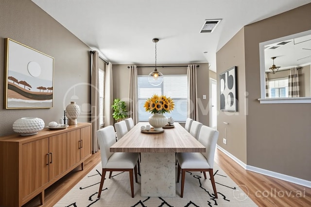 dining space featuring visible vents, light wood finished floors, and baseboards