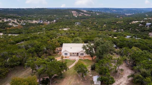 bird's eye view with a wooded view