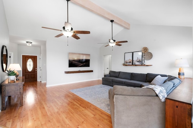 living room featuring ceiling fan, vaulted ceiling with beams, and hardwood / wood-style flooring