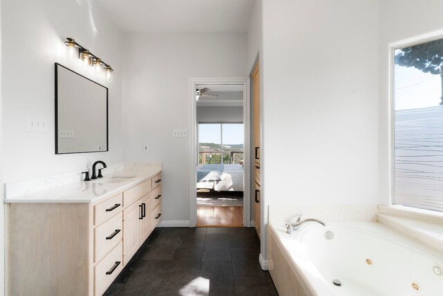 bathroom featuring vanity, tile patterned flooring, and tiled tub