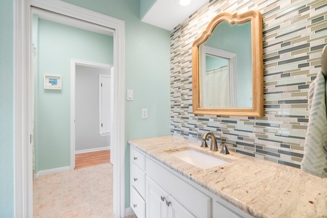 bathroom with tile patterned flooring, tasteful backsplash, and vanity