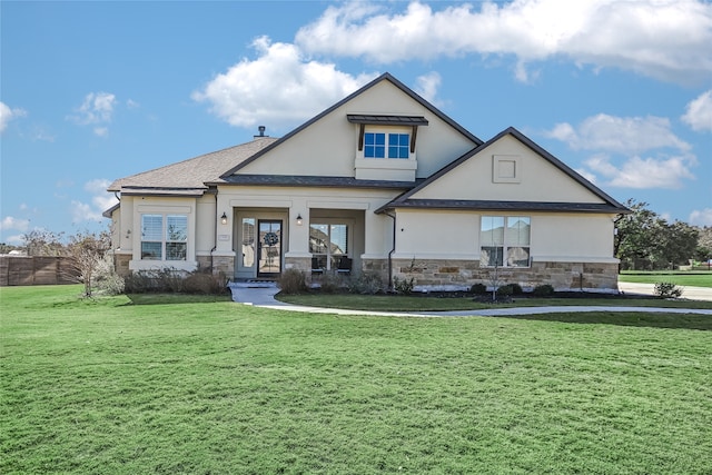 rear view of house featuring a lawn and a porch