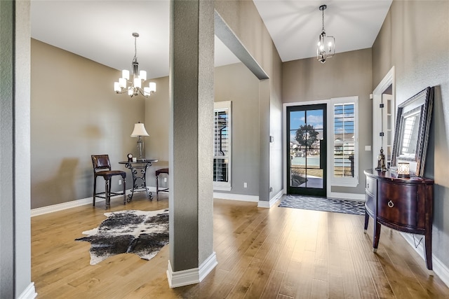 entryway with a chandelier and hardwood / wood-style flooring