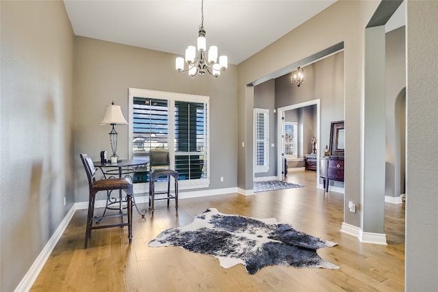 sitting room with wood-type flooring and a notable chandelier