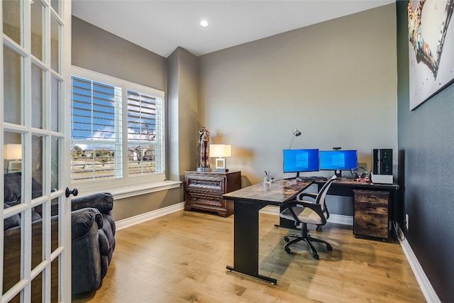 office space featuring light hardwood / wood-style floors and french doors