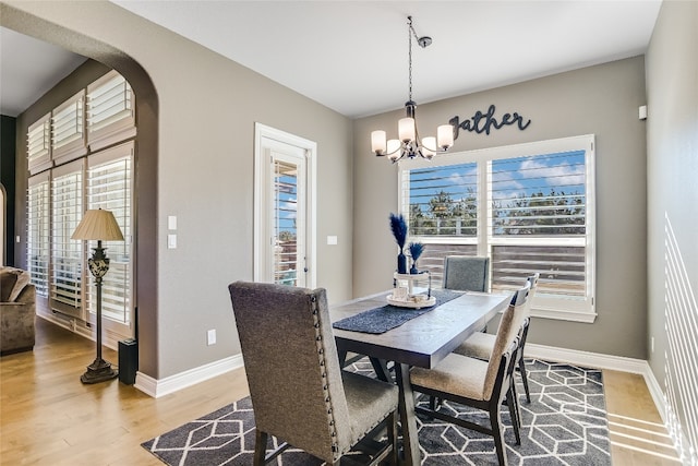 dining area featuring hardwood / wood-style floors, a chandelier, and plenty of natural light